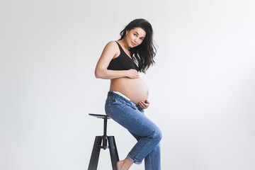 Pregnant woman standing on stool