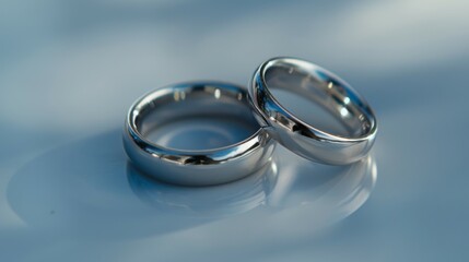 Silver shiny rings reflecting love and engagement with a wedding promise