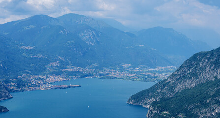 Mountain landscape, picturesque mountain lake in the summer morning, large panorama, landscape with fabulous lake view from the top of the mountain, with view of city. Iseo, Italy