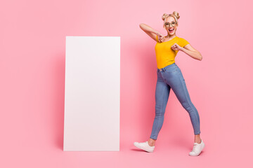 Full length photo of cute blond lady dance near promo wear t-shirt jeans footwear isolated on pink background - Powered by Adobe