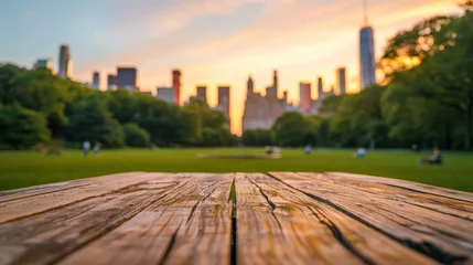 Tuinposter Wooden Table in Park With City Skyline © tashechka