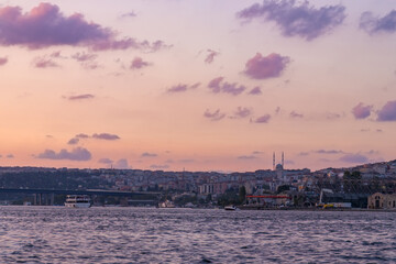 View of Istanbul from the ferry at sunset in purple and pink. Travel to Turkey, Istanbul.