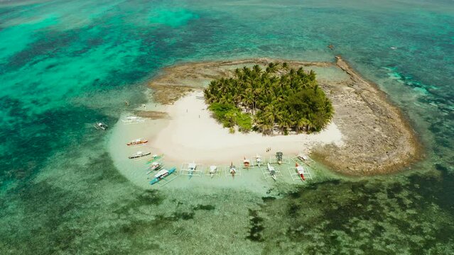 Tropical island with palm tree, beach with tourists and boats. Guyam island, Philippines, Siargao. Summer and travel vacation concept