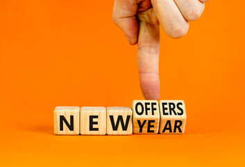New year and offers symbol. Concept word New year New offers on beautiful wooden cubes. Beautiful orange table orange background. Businessman hand. Business new year and offers concept. Copy space.