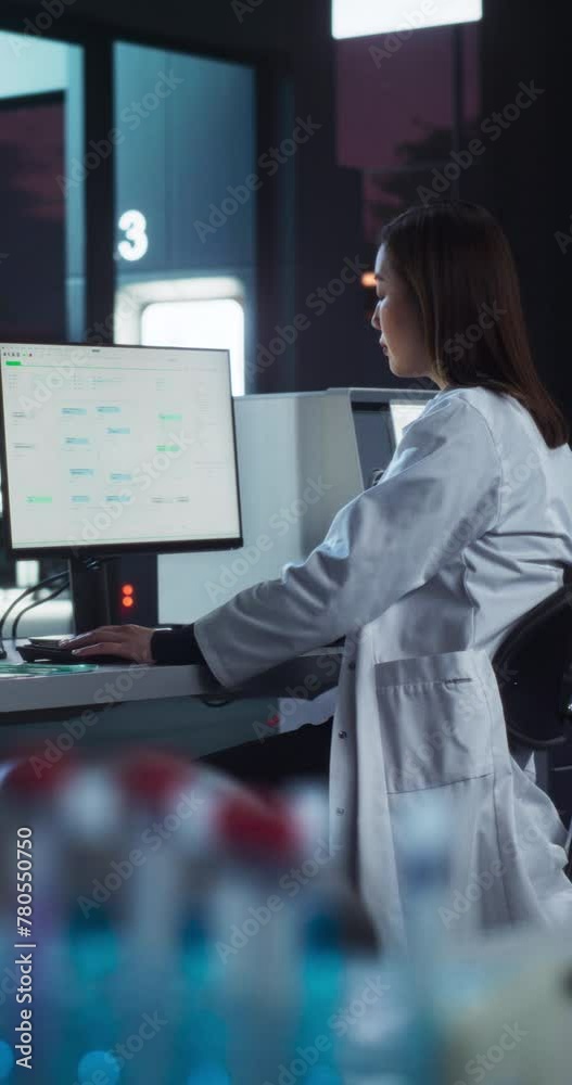 Poster vertical screen: asian female scientist working on a desktop computer, analyzing dna samples alone i