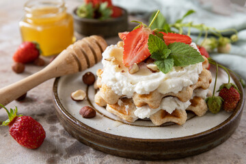Belgian waffles with fresh berrie strawberries and ricotta cheese for breakfast on a stone background. - 780553552
