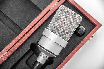 Podcast studio microphone in a case on a white background.