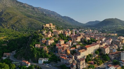 Fototapeta na wymiar Aerial view of Corte old town, Corsica island. Morning shot of old houses on the hill in Corte village, Corsica, France