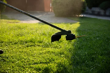 Fotobehang Lawn mover on green grass. Machine for cutting lawns. © erika8213