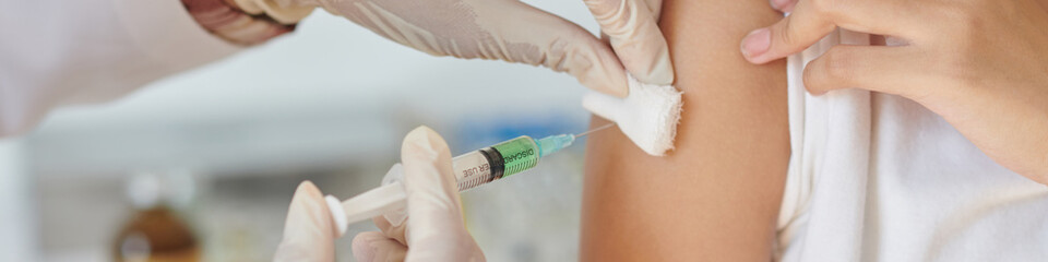 Web banner with medical nurse injecting vaccine against virus