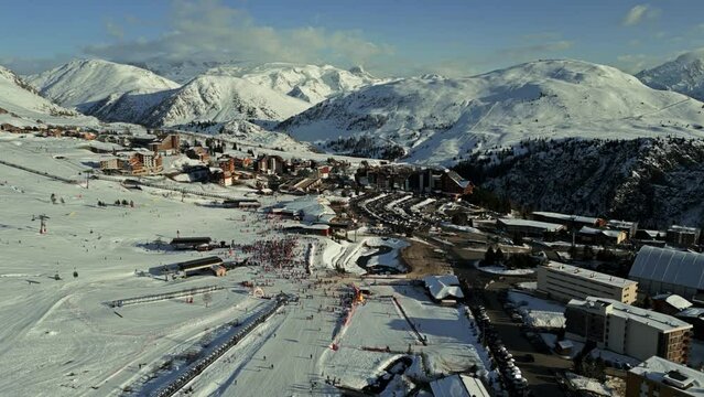 Aerial shot of Alpe d'Huez ski resort on a winter sunny day, high season, France