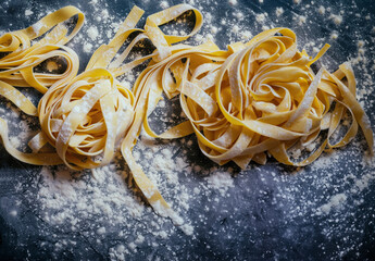 Raw Nest of fresh linguine pasta homemade, top view