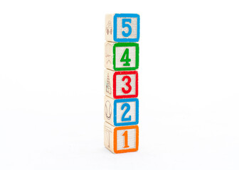 Wooden number blocks 54321 isolated on white background.