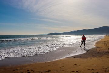 Girl walking on the beach. Girl and the sea. Travel and tourism.