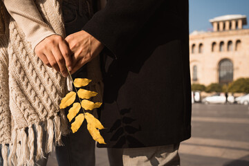 Autumn in Armenia. Couple in love holding golden leaf at central square of Yerevan