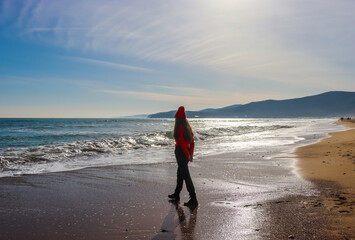 Girl walking on the beach. Girl and the sea. Travel and tourism.