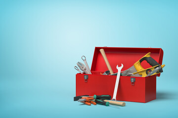 Partially filled toolbox with tools on blue