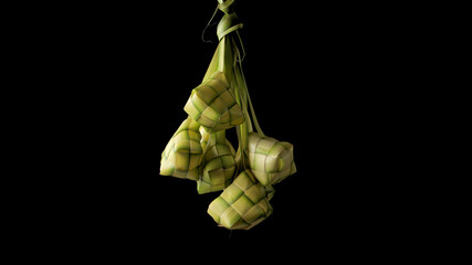 Hand presenting a ketupat pouch, a traditional Indonesian dish, woven from young coconut leaves...