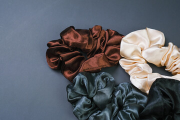 Three Scrunchies of Different Colors on Gray Surface