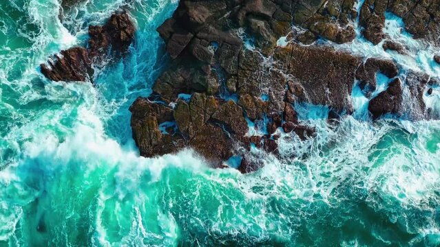 aerial view bird eye seashore with big wave crashing on rock cliff. beautiful waves sea surface in sunny day summer background. amazing seascape top view seacoast landscape view