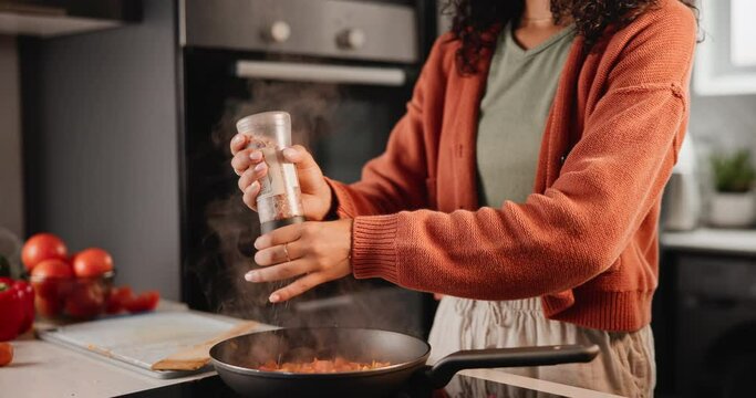 Hands, woman and cooking vegetables with spices in kitchen for dinner with seasoning and frying at home. Female person, closeup and vegetarian food for healthy meal, ingredients for flavor.