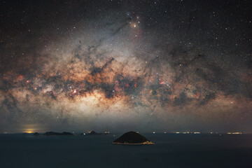 Majestic Milky Way Arcing Over Solitary Island Under Starlit Night Sky