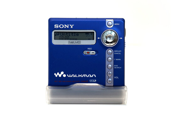 Retro vibrant blue portable Sony minidisc player isolated on a white background. Playing an untitled track.