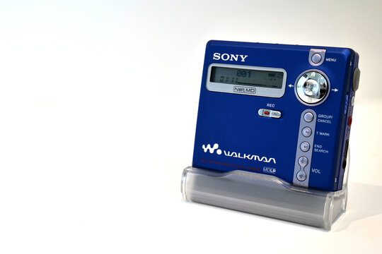 Retro vibrant blue portable Sony minidisc player isolated on a white background. Playing the 1st track on a disc