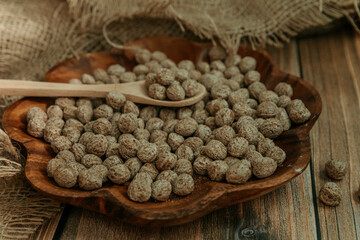 Breakfast cereal, bran with wooden spoon and ears of corn on wooden background