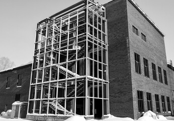 Metal frame of the building with a sandwich panel of insulation on the wall. Construction of a new commercial building. Black and White. Ust-Kamenogorsk, (kazakhstan)