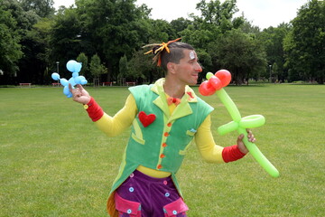 Circus juggler portrait. Clown juggling with objects.