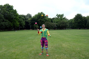 Fototapeta premium Circus juggler portrait. Clown juggling with objects.