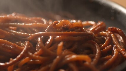 Steaming Pasta with Tomato Sauce. Step of Recipe Fried Assassin's Spaghetti Cooking. Close-up,...