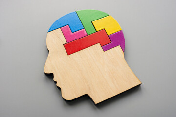 Head made from colored puzzle pieces. Autism, neurodiversity or creativity concept. - obrazy, fototapety, plakaty