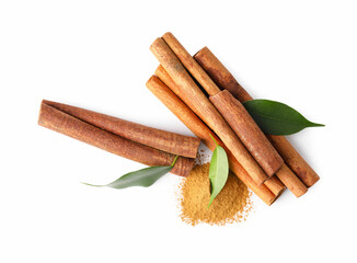 Dry aromatic cinnamon sticks, powder and green leaves isolated on white, top view