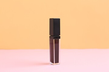 One purple lip gloss on color background