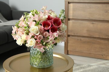 Beautiful bouquet of fresh flowers on coffee table in room, space for text