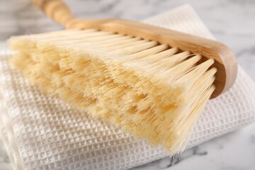 One cleaning brush and rag on table, closeup