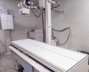 X-ray department in modern hospital. Radiology room with scan machine with empty bed. Scanning chest, heart, lungs in modern clinic office. - Powered by Adobe