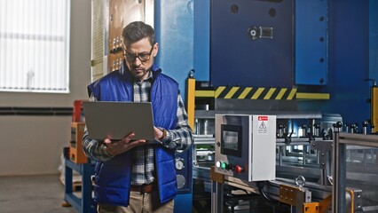 Close-up portrait of serious concerned hard-working Caucasian middle-aged male at workplace. Thoughtful handsome attractive man looks in his tablet and tap the electrician panel screen.