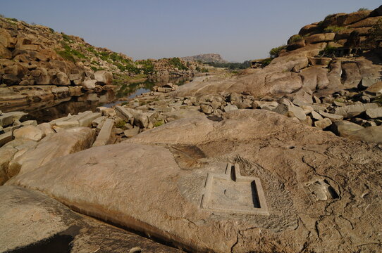 Tungabhadra River and stone cut Shiva Linga, Hampi, Karnataka, India