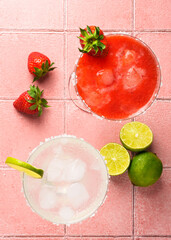 Margarita cocktails. Classic and strawberry margarita with tequila, ice and lime with ingredients at color background. - 780620741