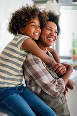 African american woman hugging her smiling teen daughter. Family love single parent child concept - 780621783