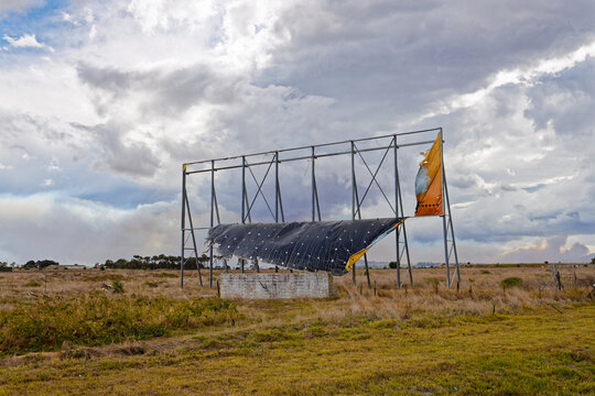 A large signboard in tatters after an extreme storm over the Western Cape, South Africa.