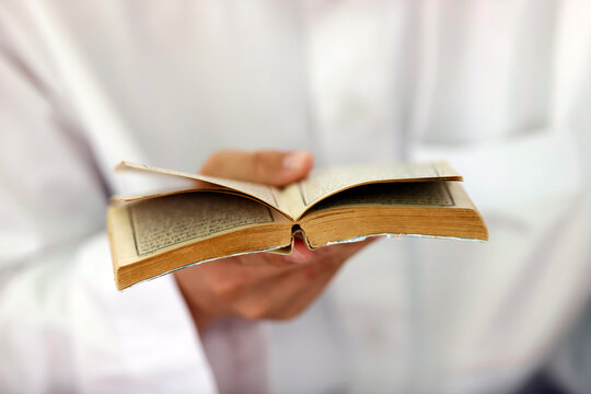 Muslim man reading an Arabic Holy Quran (Koran), Jamiul Azhar Mosque, Vietnam, Indochina, Southeast Asia