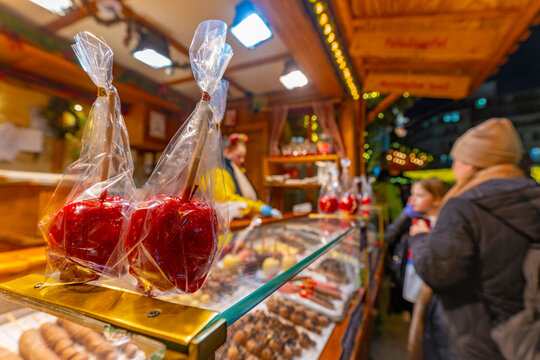 View of toffee apples on Christmas Market stall in Victoria Square at dusk, Birmingham, West Midlands, England, United Kingdom