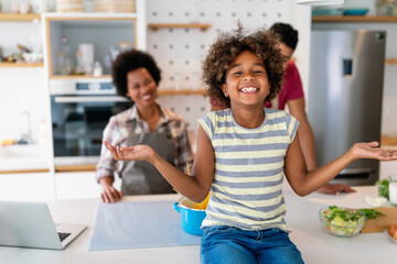 Happy african american family preparing healthy food in kitchen, having fun together on weekend - 780625708
