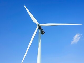 A large wind turbine is standing tall in the sky above a clear blue sky