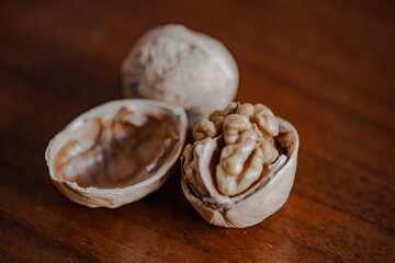Walnuts that have been smashed open for consumption, with walnut skins on the table