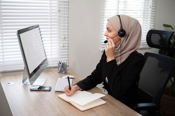 Young muslim women wearing hijab telemarketing or call center agent with headset working on support...